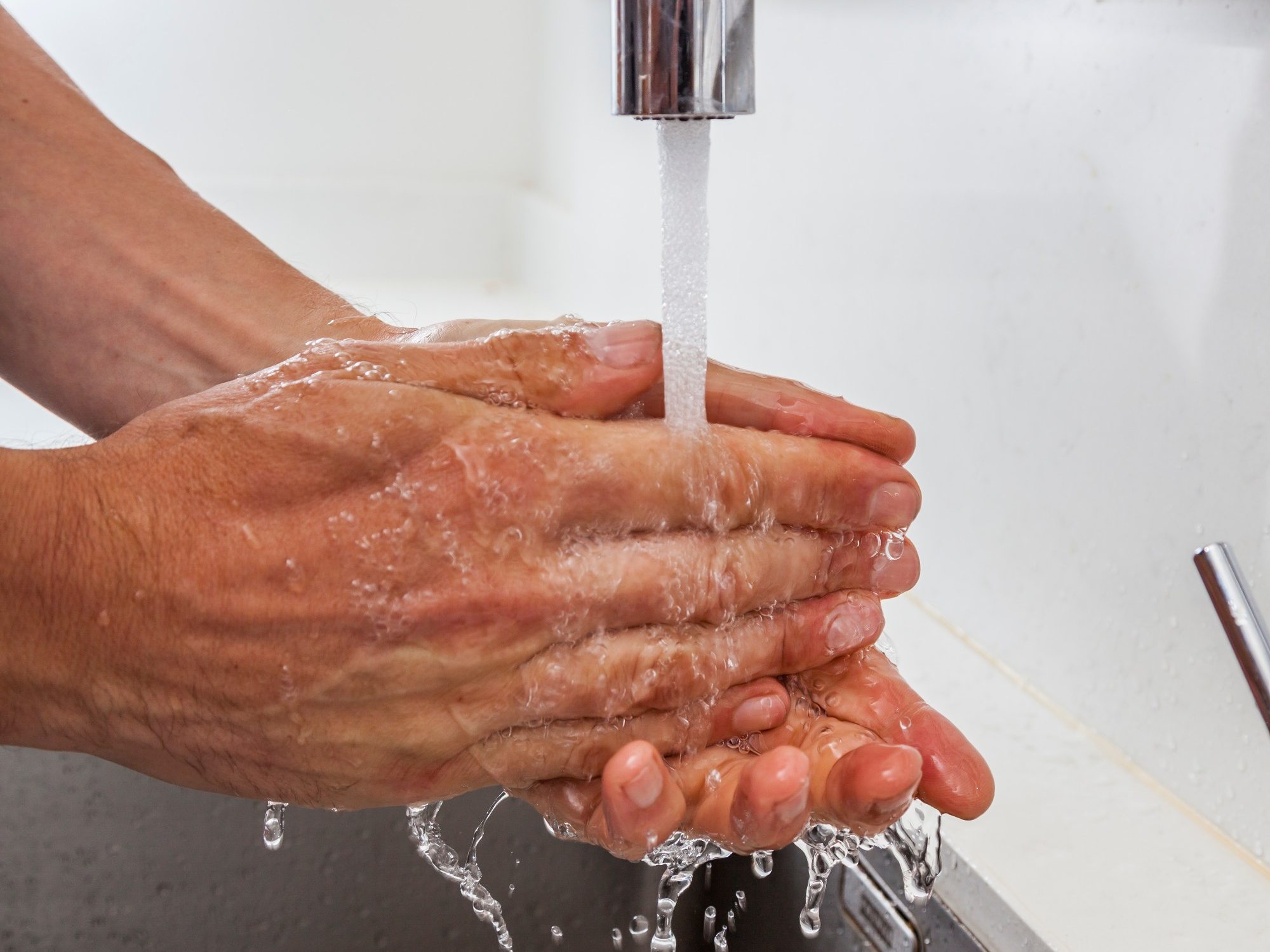 Washing hands under running water