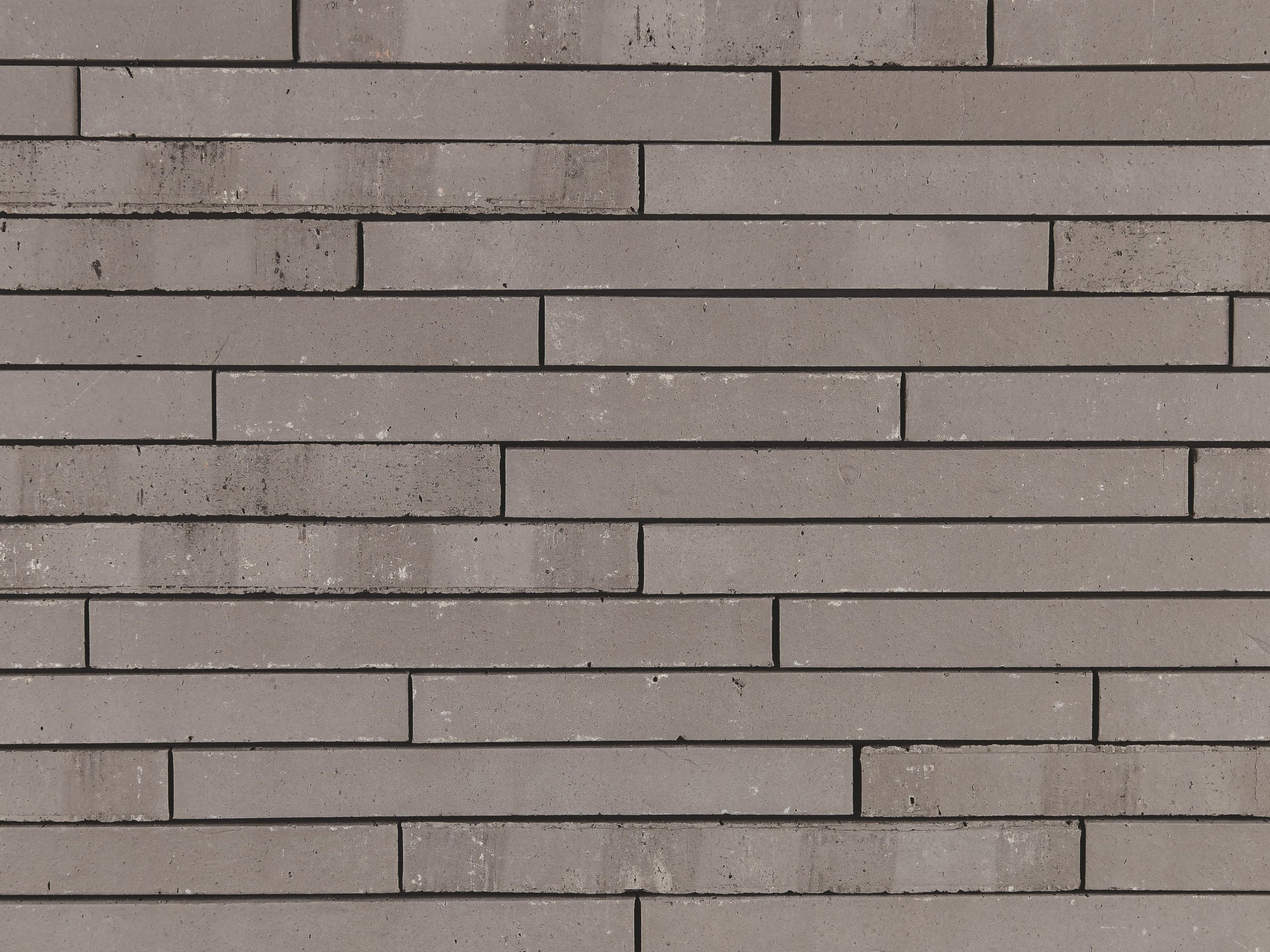 Archipolis Frost Grijs facing bricks in a soft wild bond with a glued application