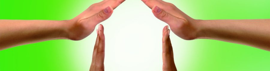 Conceptual symbol home made from black and white hands isolated over white background