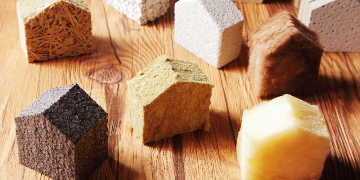 Close up Various Scattered Blocks of insulation Model Hous in Different Standing on Top of the Wooden Table