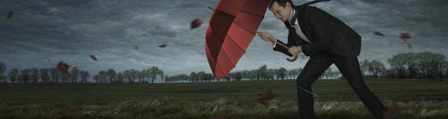 Crisis, trouble, problems concept. Businessman walks in the storm with copy space